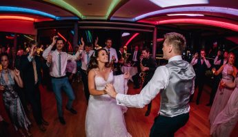 husband and wife share first dance played by their wedding band