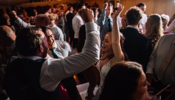 Bride dancing with guests to DJ and Sax duo. Taken by wedding photographer Chris Werret.