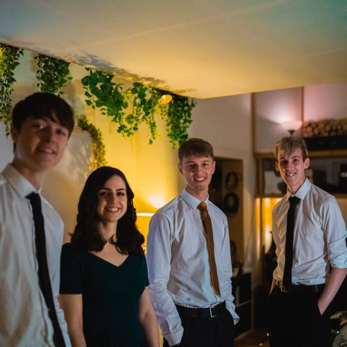 Musicians from the Soul Station wedding band for hire stood in a recording studio.