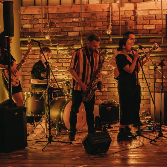 Yorkshire wedding band Cat and Mac performing with a sax at Crimple Hall.