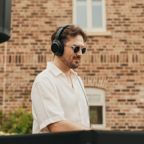 Relaxed wedding DJ hire ready to spin tracks at an outdoor wedding.